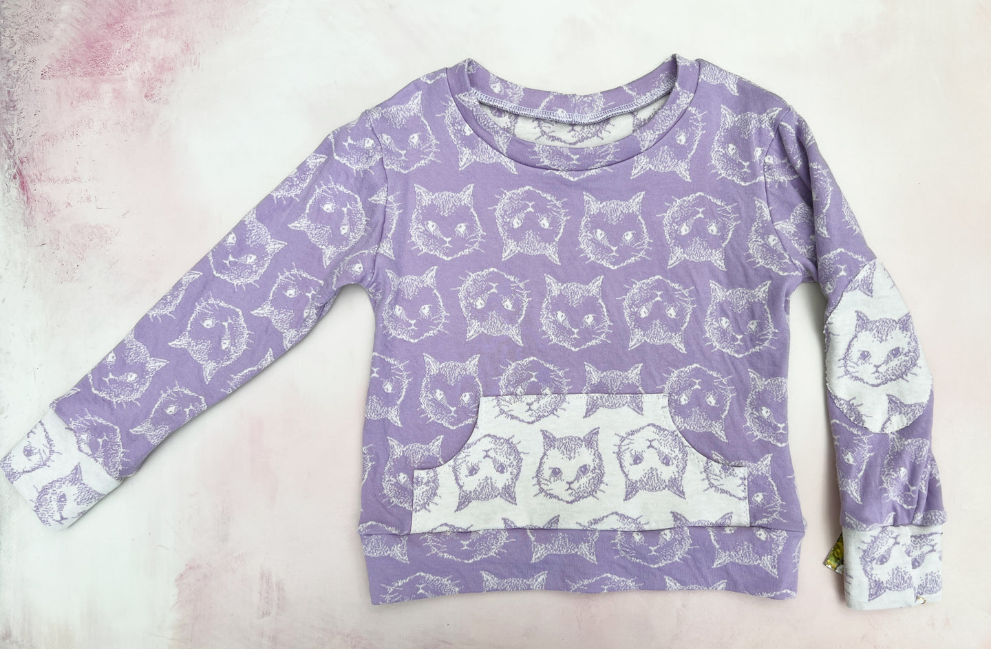purple cat heads sweater