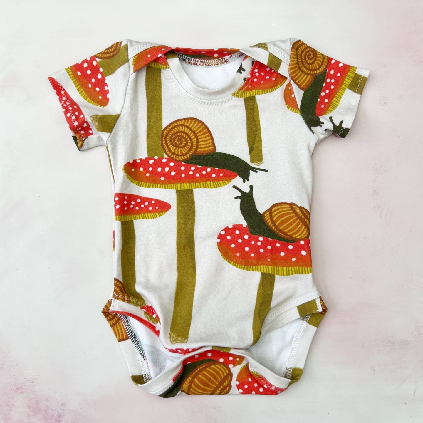 snails and mushies onesie