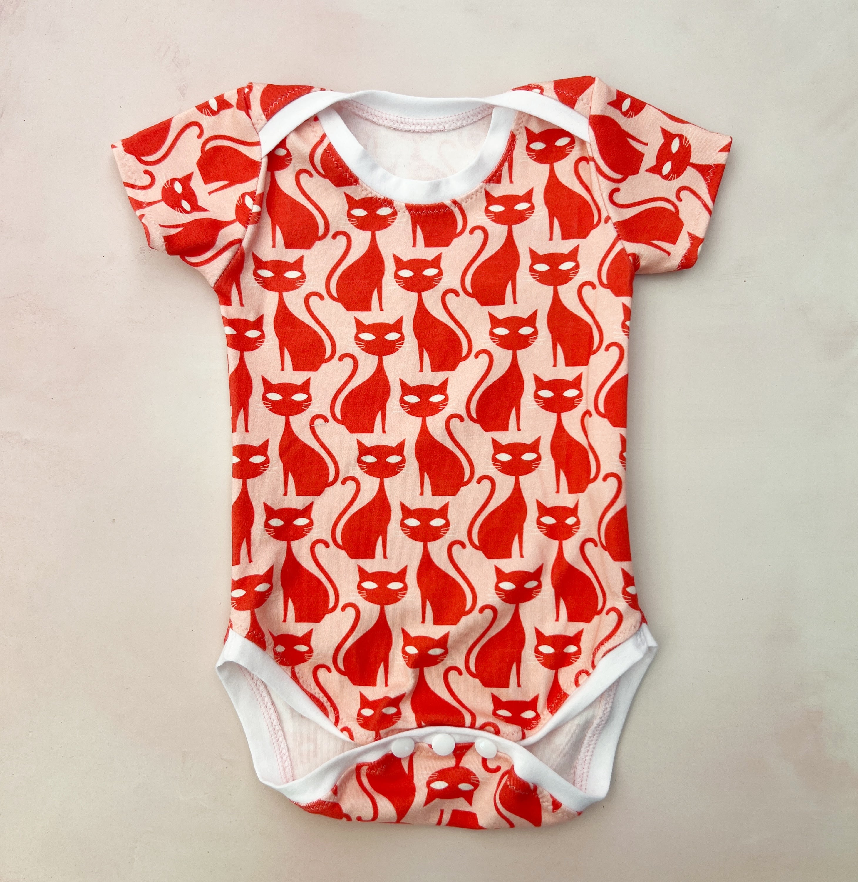 pink and red cats onesie